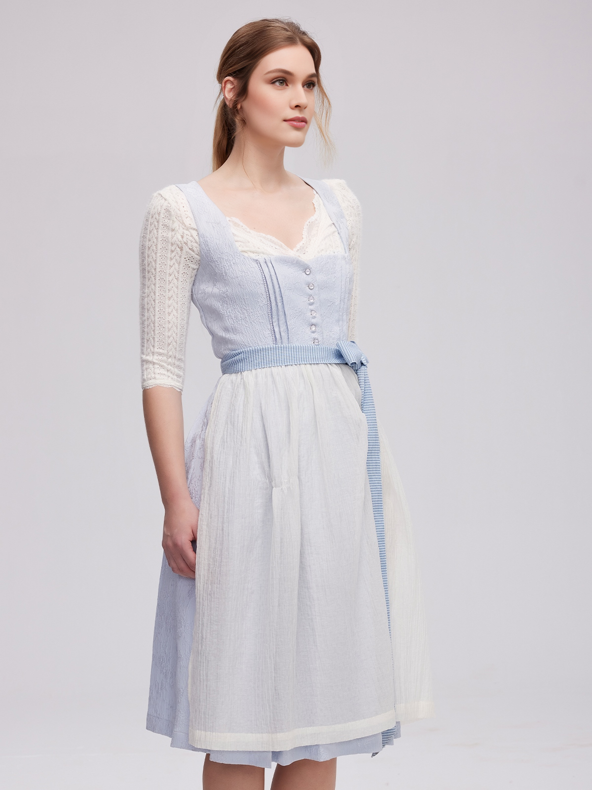 Eine moderne langarm Dirndl Bluse in Blau mit Spitzenverzierungen